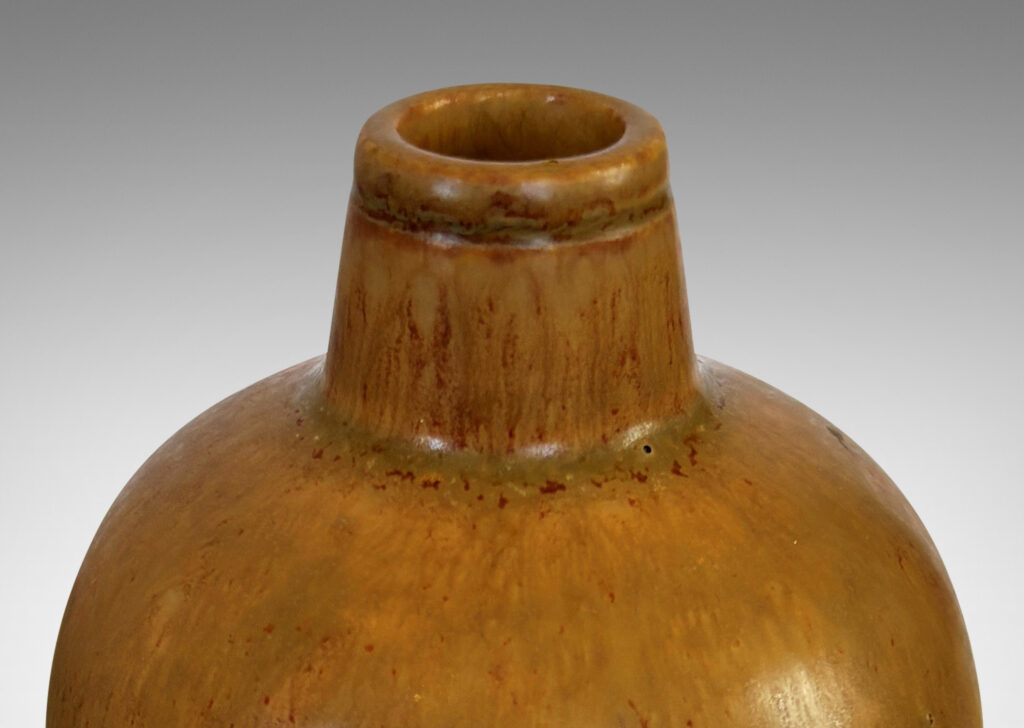 Gallery BAC sinuous form with swelling shoulders and a small conical neck, glazed in eggshell finish ochre-tan with red-brown