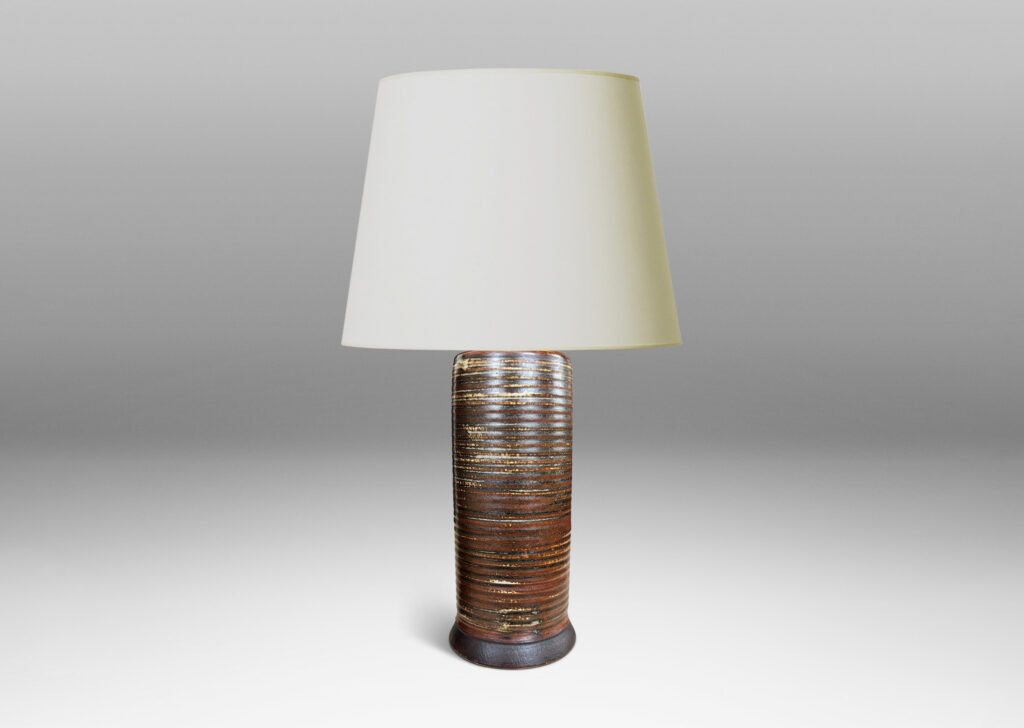 Gallery BAC ridged cylindrical forms glazed in a warm brown and pale gray “Sung” glaze, with matte brown angled plinths