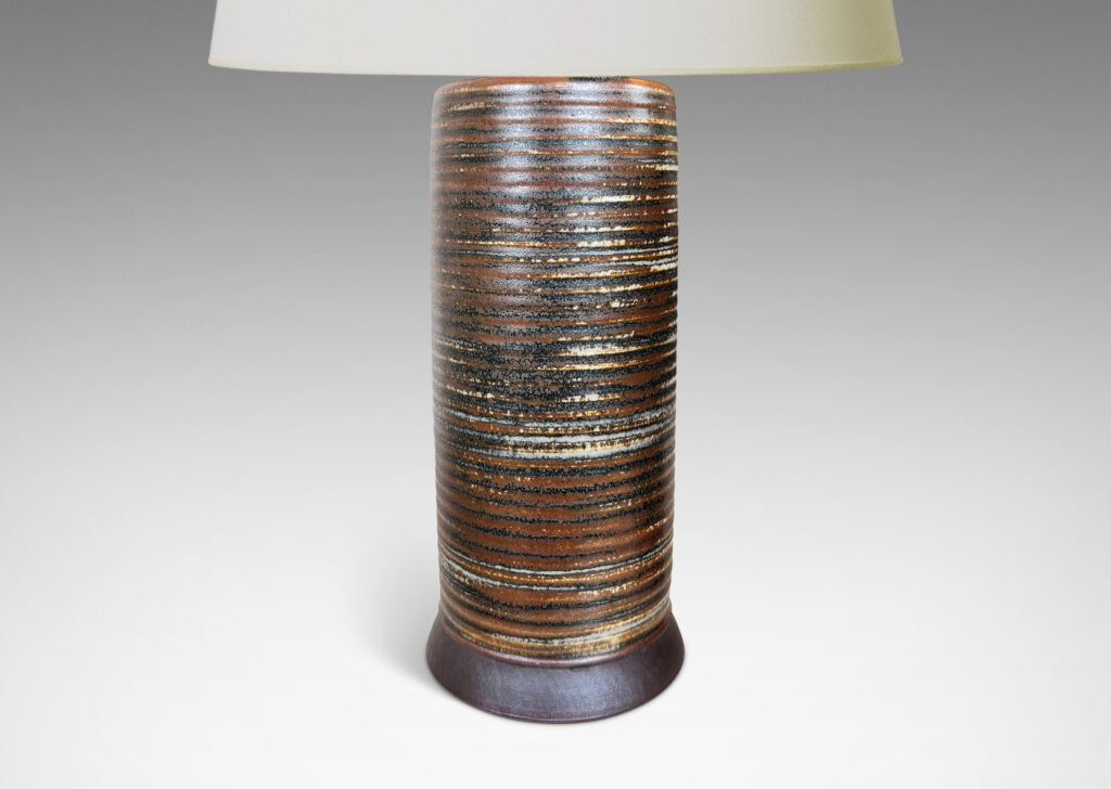 Gallery BAC ridged cylindrical forms glazed in a warm brown and pale gray “Sung” glaze, with matte brown angled plinths