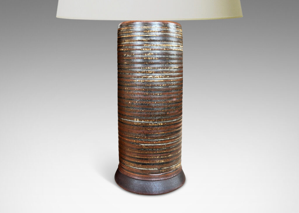 Gallery BAC ridged cylindrical forms glazed in a warm brown and pale gray “Sung” glaze, with matte brown angled plinths