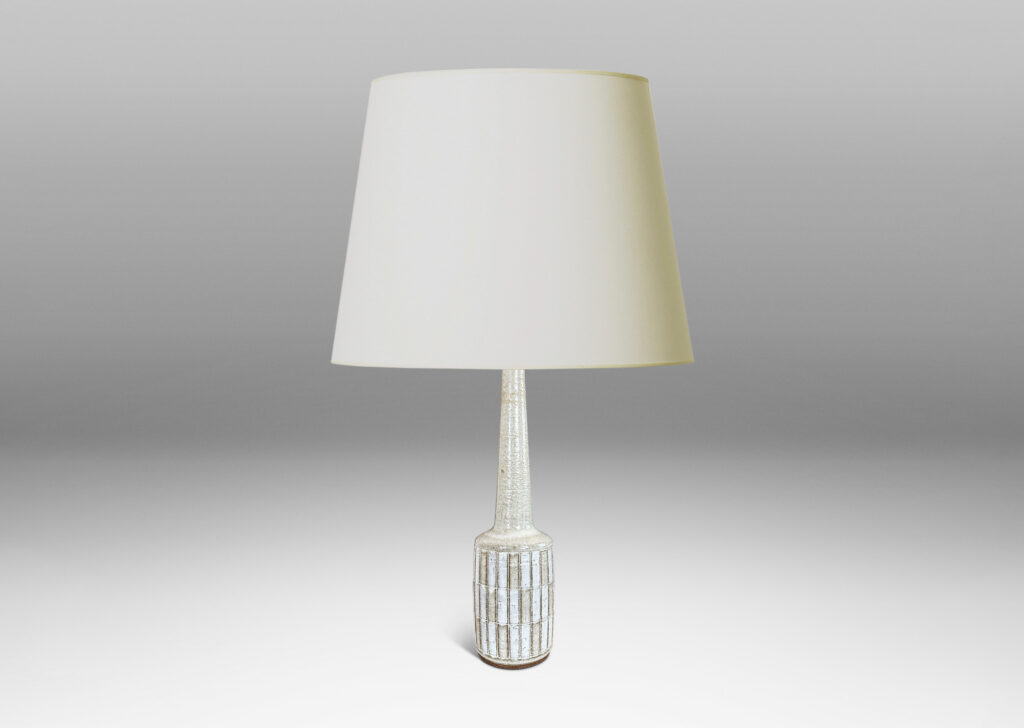 Gallery BAC cylindrical form with carved grid design, and tall conical neck, glazed in pale gray and white