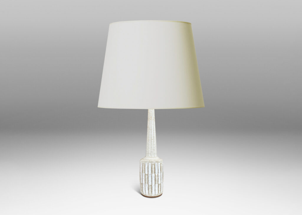 Gallery BAC cylindrical form with carved grid design, and tall conical neck, glazed in pale gray and white