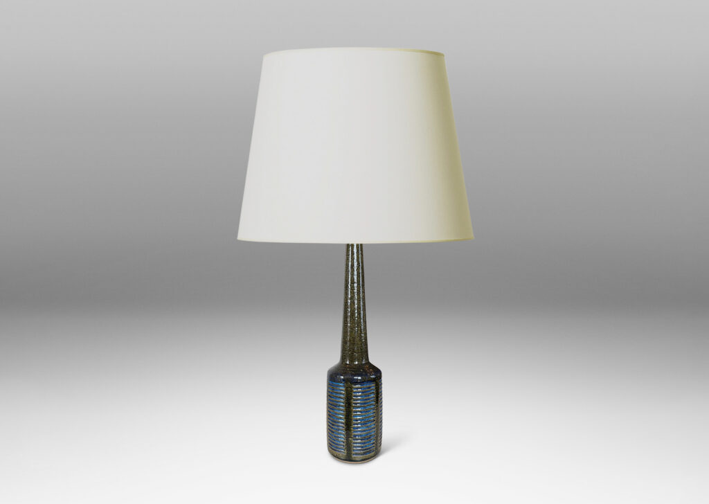 Gallery BAC drum form with vertical bands of carved lines, and tall conical neck, in a grog texture; glazed in gloss dark green with blue