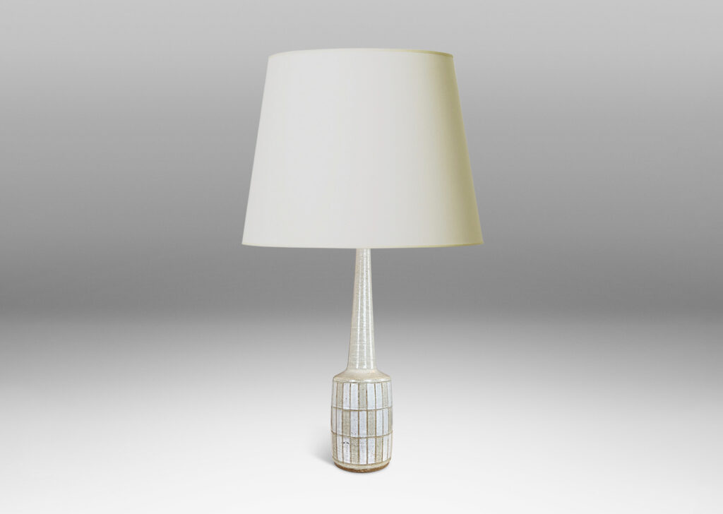Gallery BAC cylindrical form with carved grid design, and tall conical neck, glazed in pale gray and white