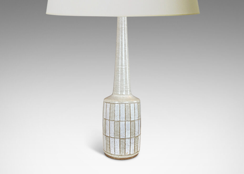Gallery BAC cylindrical form with carved grid design, and tall conical neck, glazed in pale gray and white