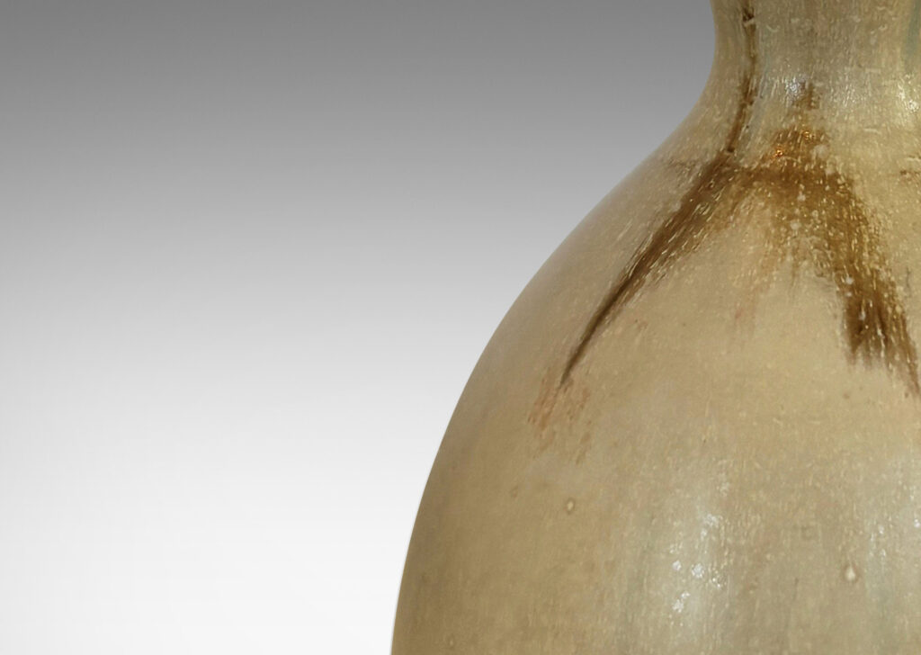 Gallery BAC sinuously modeled double gourd form, glazed in a flowing pale tan with flushes of brown