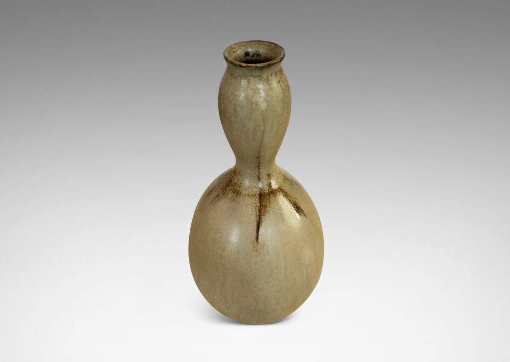 Gallery BAC sinuously modeled double gourd form, glazed in a flowing pale tan with flushes of brown
