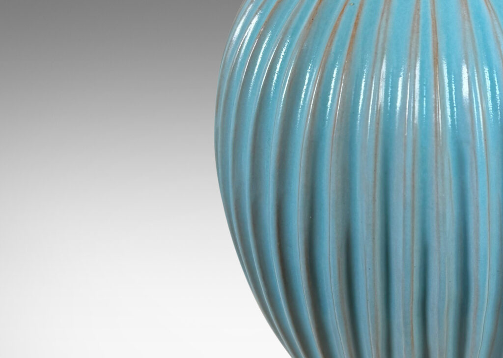 Gallery BAC fluted balloon form on a disk plinth, glazed in semi-shine light blue