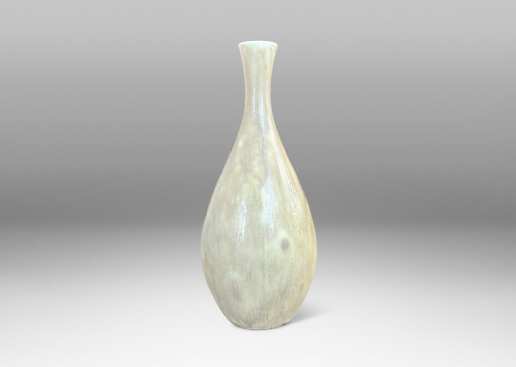Gallery BAC sinuous swelling form with delicately flared neck, glazed in a flowing yellow-tan