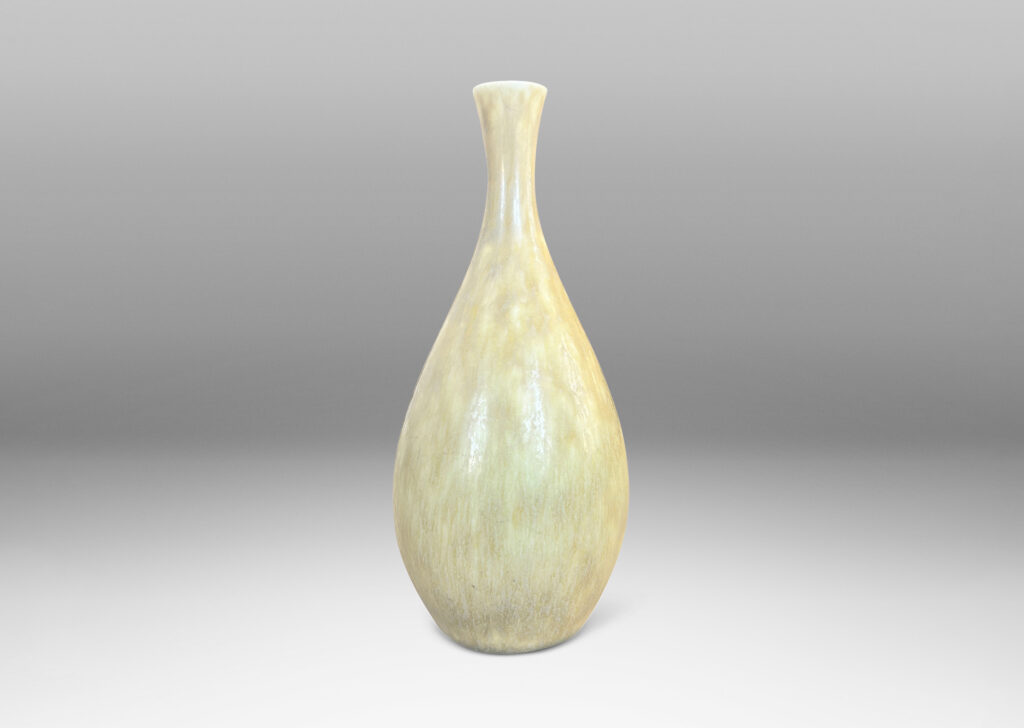 Gallery BAC sinuous swelling form with delicately flared neck, glazed in a flowing yellow-tan