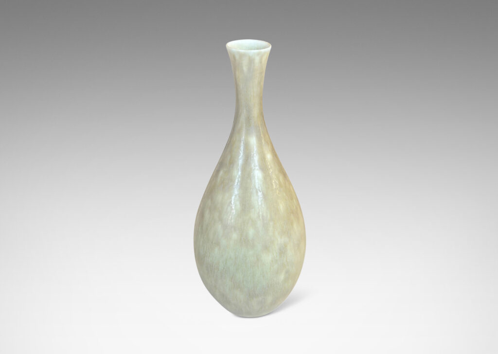 Gallery BAC sinuous swelling form with delicately flared neck, glazed in a flowing yellow-tan