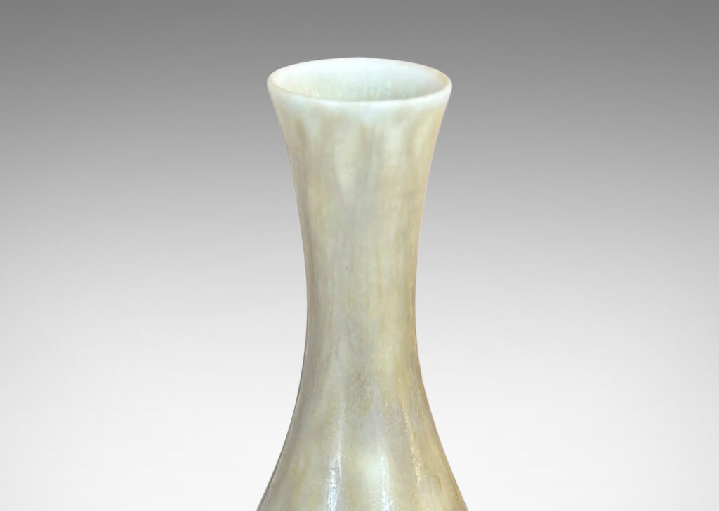 Gallery BAC sinuous swelling form with delicately flared neck, glazed in a flowing yellow-tan
