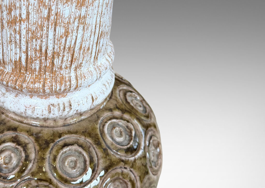 Gallery BAC plump globe forms with carved circle motifs glazed in shiny olive green-gray, and wide textured necks in partial white glaze