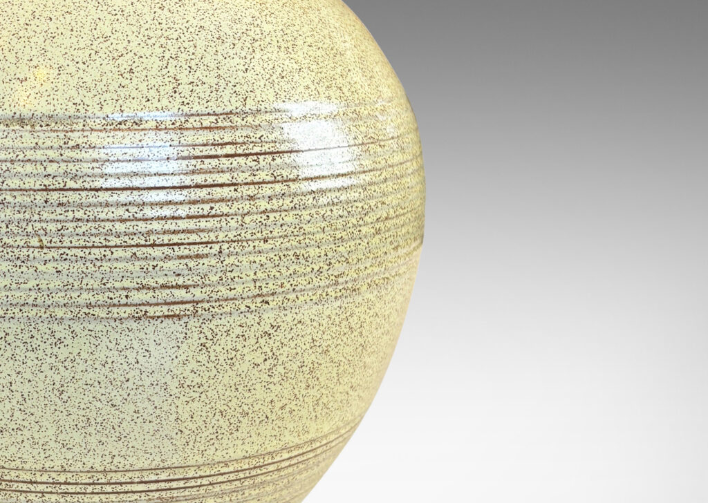 Gallery BAC tapered globe form with bands of grouped pinstripes and a short cuff neck, glazed in butter yellow with brown speckling