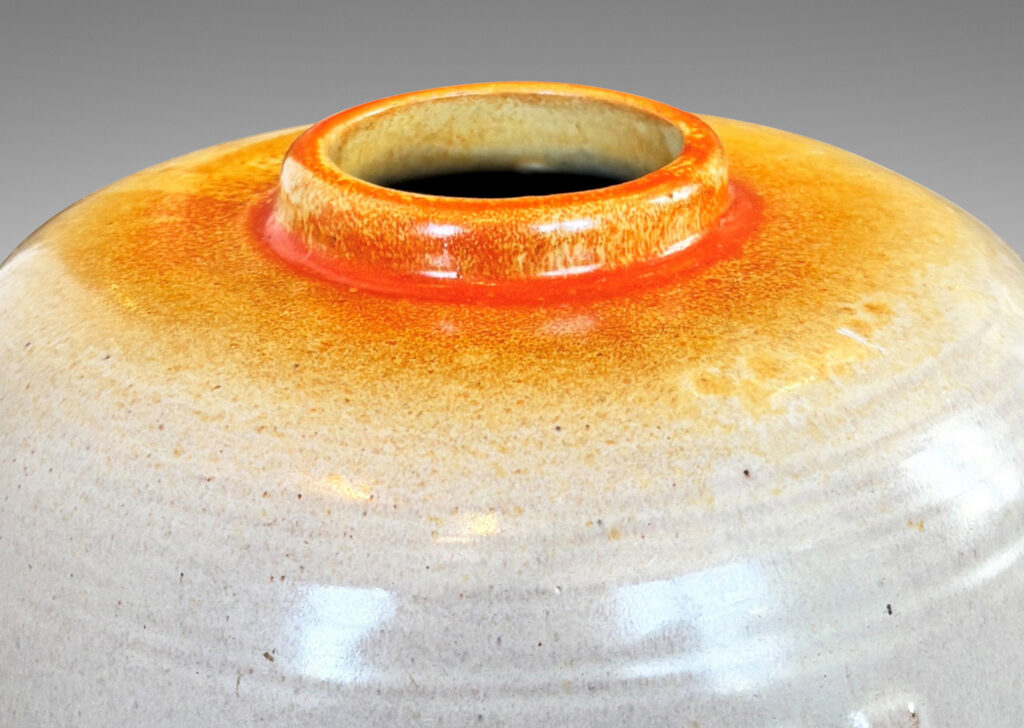 Gallery BAC ovoid form with relief abstract floral design, glazed in ivory and burnt orange