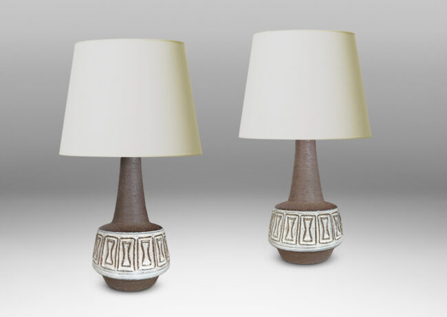 Gallery BAC drum forms with relief hourglass motifs and conical necks, glazed in matte brown