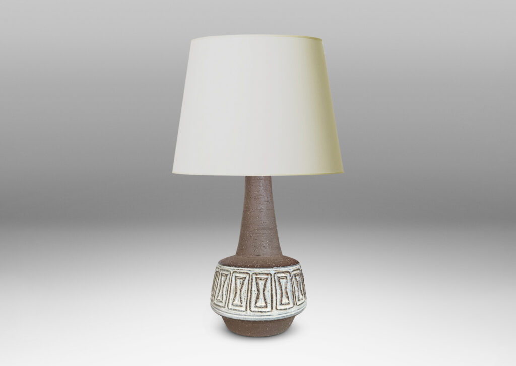 Gallery BAC drum forms with relief hourglass motifs and conical necks, glazed in matte brown