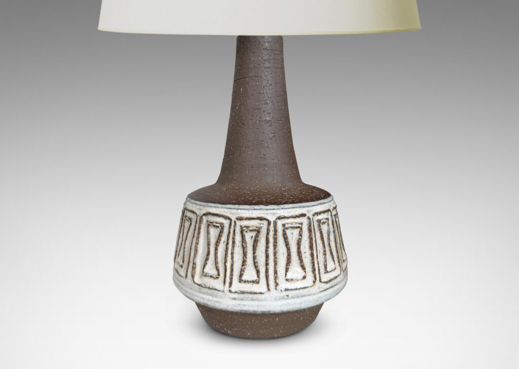 Gallery BAC drum forms with relief hourglass motifs and conical necks, glazed in matte brown