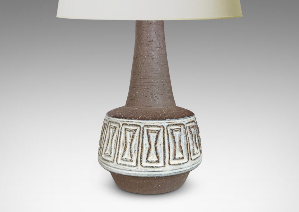 Gallery BAC drum forms with relief hourglass motifs and conical necks, glazed in matte brown