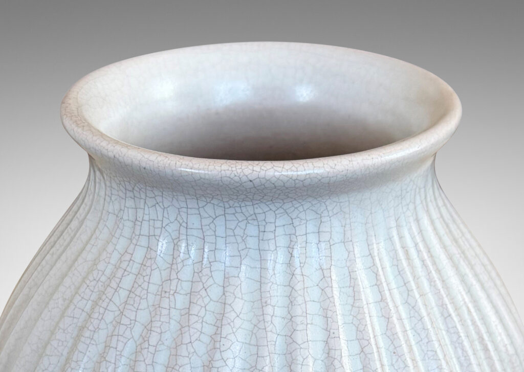 Gallery BAC ribbed ovoid form with wide outstretched mouth, glazed in a semi-shine off-white glaze