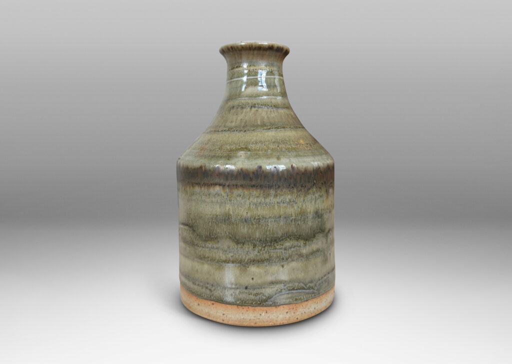 Gallery BAC cylindrical bottle-like form with sprouting mouth, glazed in a striae-effect flowing greenish-gray
