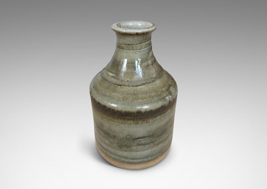 Gallery BAC cylindrical bottle-like form with sprouting mouth, glazed in a striae-effect flowing greenish-gray