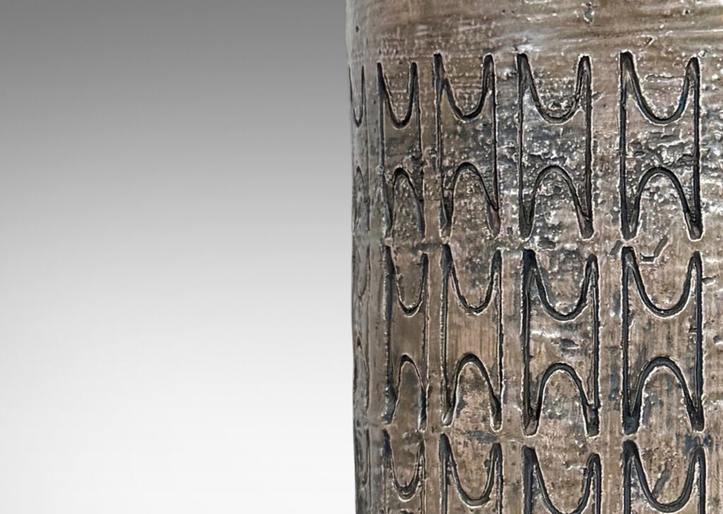 Gallery BAC columnar forms with carved ornamental motifs, glazed in a lightly lustrous grey-brown