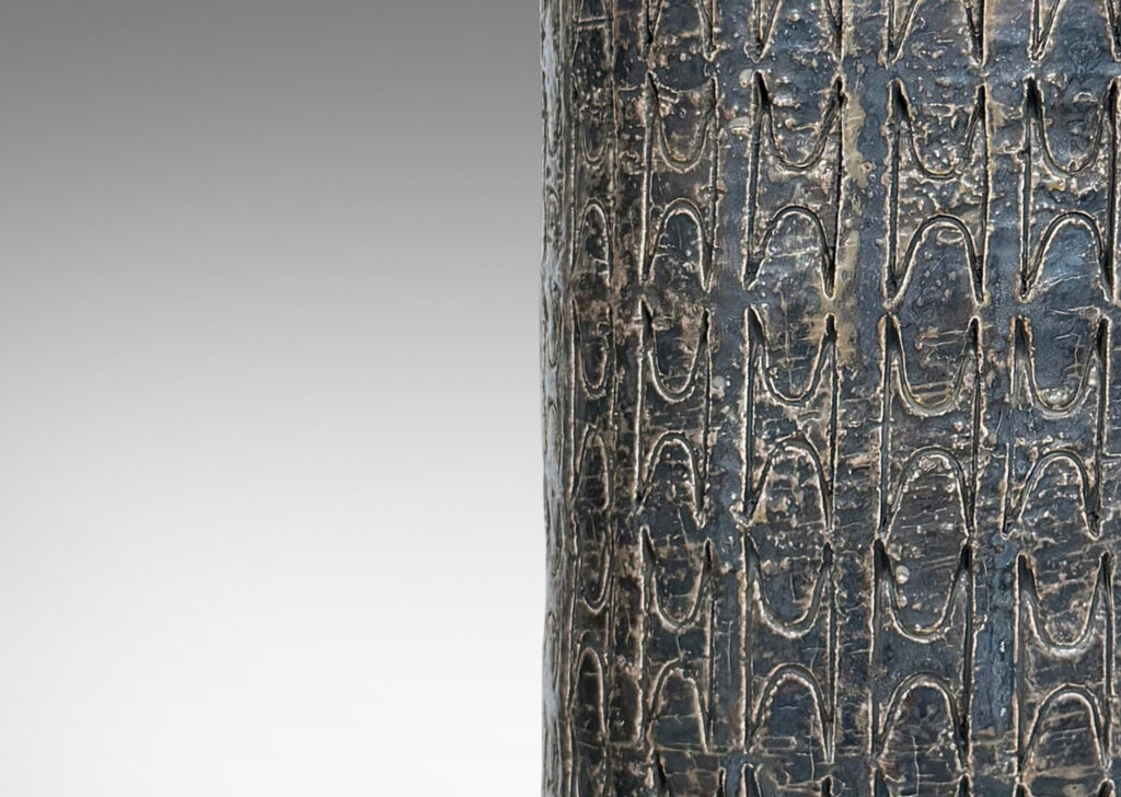 Gallery BAC columnar forms with carved ornamental motifs, glazed in a lightly lustrous grey-brown