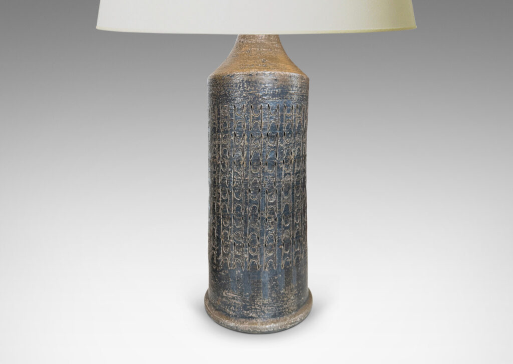 Gallery BAC columnar forms with carved ornamental motifs, glazed in a lightly lustrous grey-brown