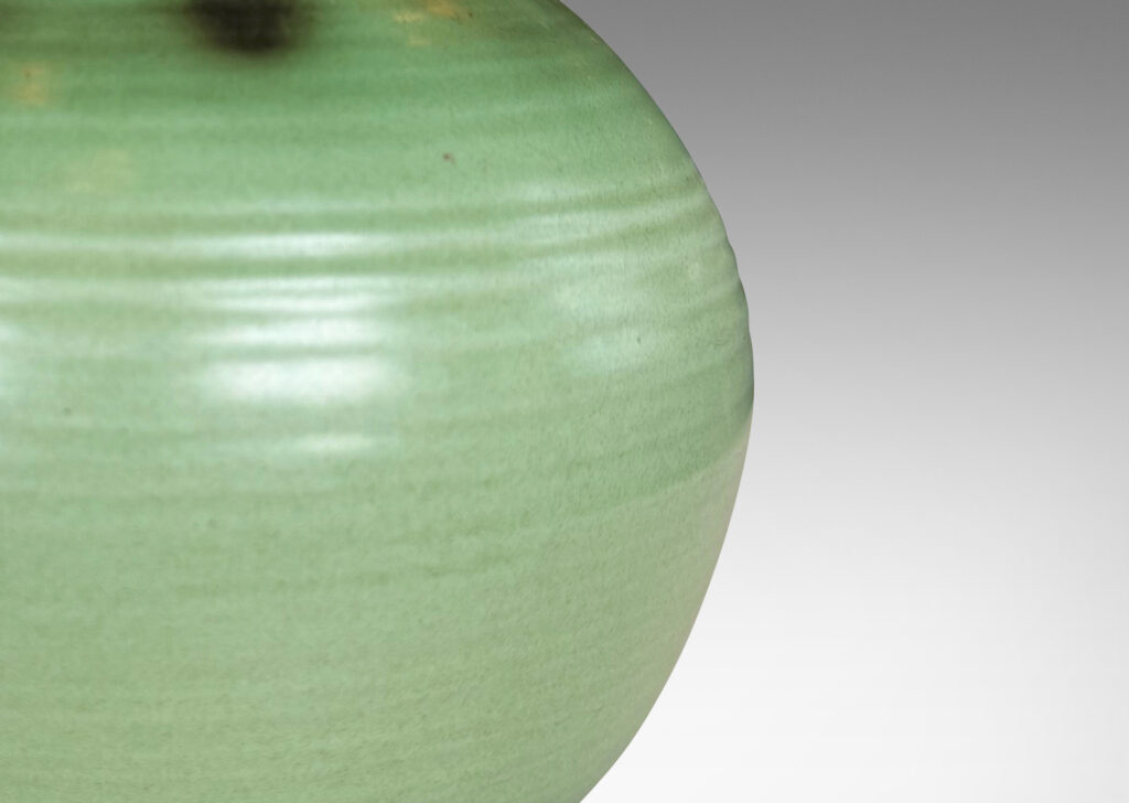 Gallery BAC ridged globe form with flared mouth, glazed in light and dark green tones
