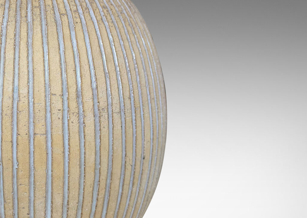 Gallery BAC light tan ovoid form with carved and white-glazed vertical pinstripes