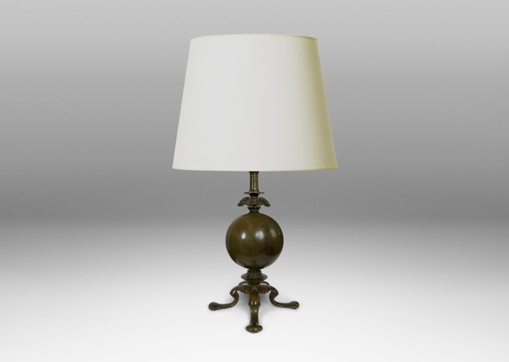 Gallery BAC spherical form on a quadrapod base with floating leaf ornaments; patinated bronze