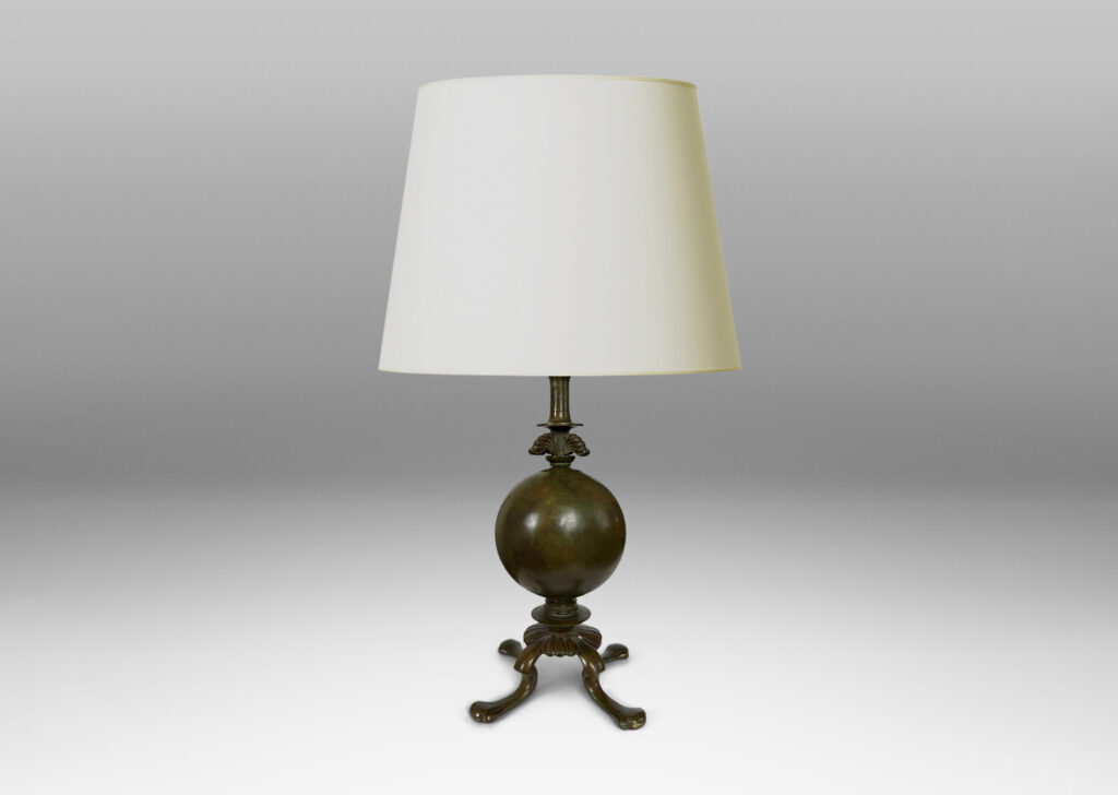 Gallery BAC spherical form on a quadrapod base with floating leaf ornaments; patinated bronze