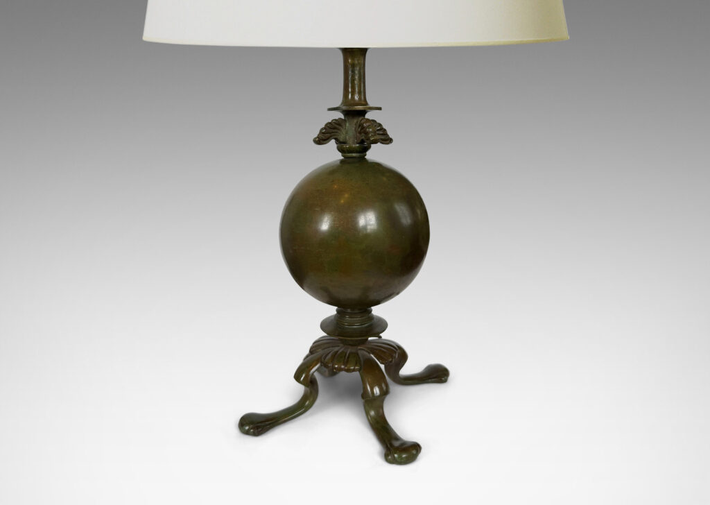 Gallery BAC spherical form on a quadrapod base with floating leaf ornaments; patinated bronze