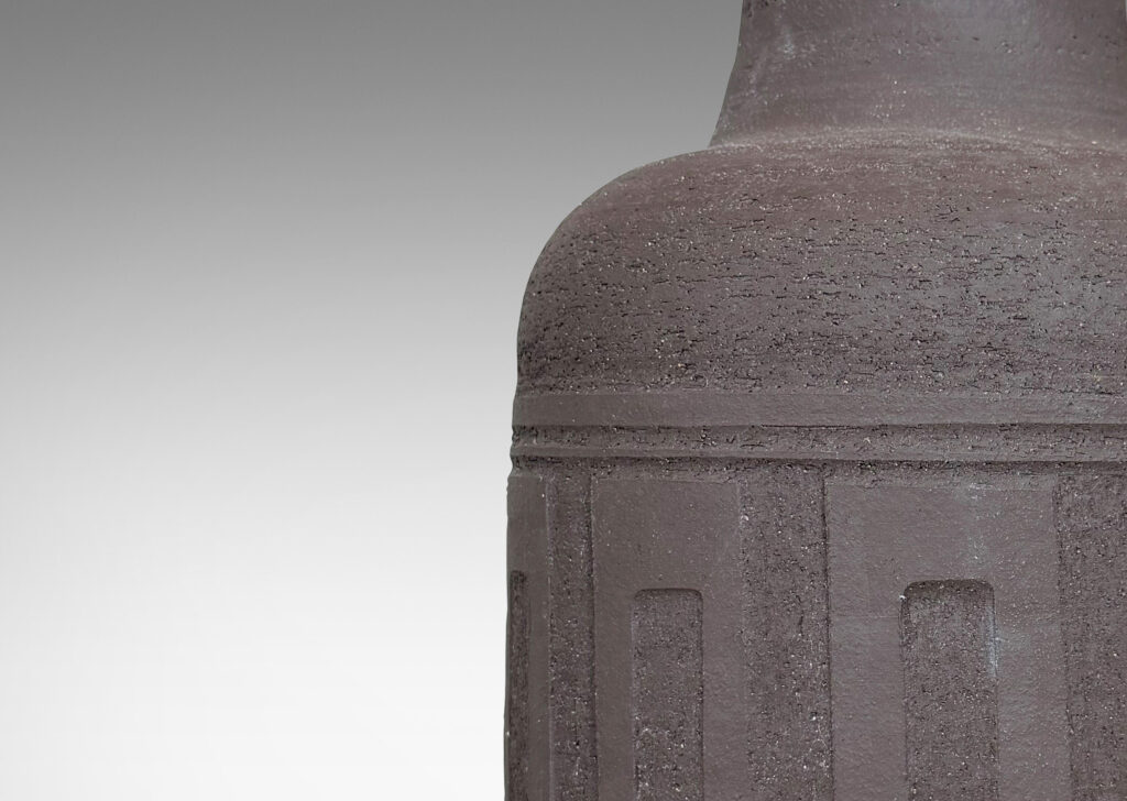 Gallery BAC tall conical neck, and band of shallow relief rectangles, glazed in a matte brown
