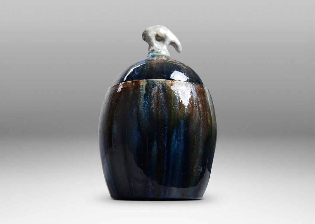Gallery BAC oval form with finial in the form of a polar bear, glazed in green-brown, blue and white