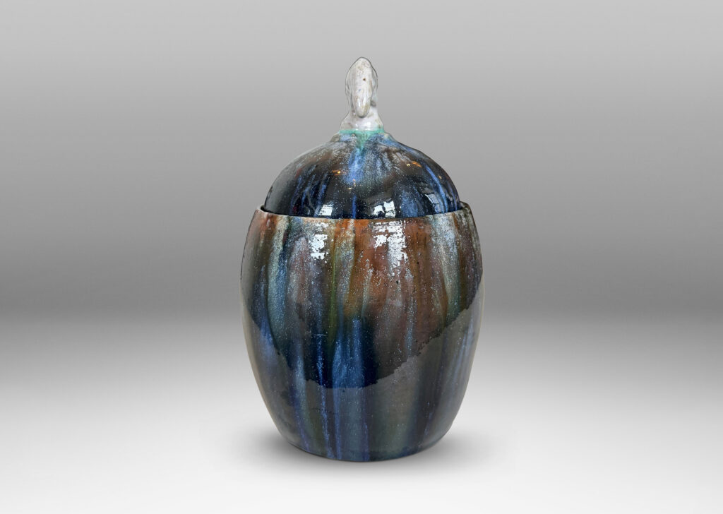 Gallery BAC oval form with finial in the form of a polar bear, glazed in green-brown, blue and white