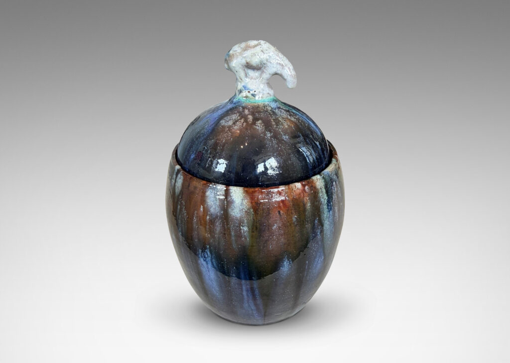 Gallery BAC oval form with finial in the form of a polar bear, glazed in green-brown, blue and white