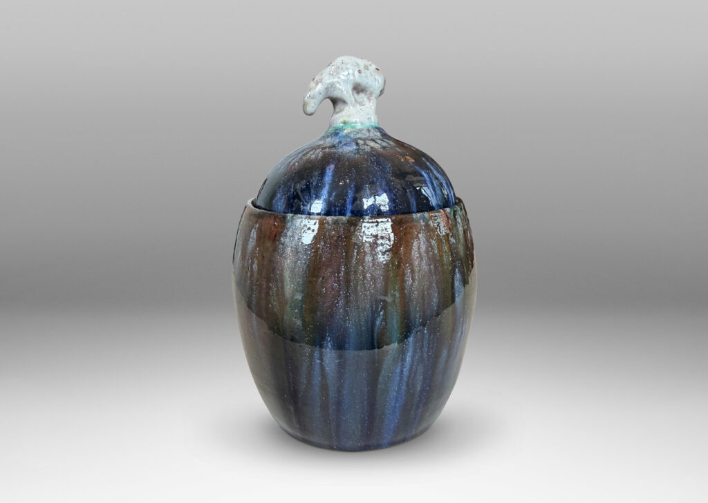 Gallery BAC oval form with finial in the form of a polar bear, glazed in green-brown, blue and white