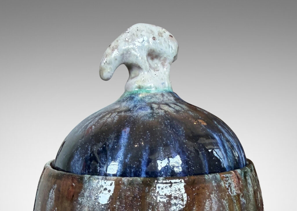 Gallery BAC oval form with finial in the form of a polar bear, glazed in green-brown, blue and white