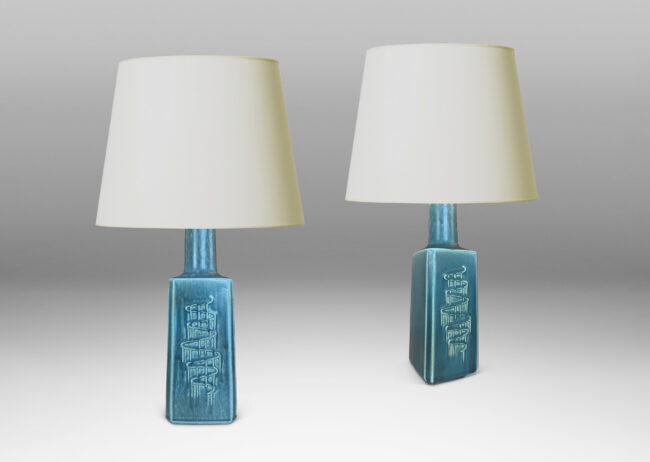 Gallery BAC square pillar forms with chamfered corners and serpentine pattern reliefs, glazed in a matte subdued turquoise