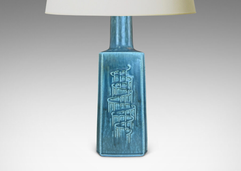 Gallery BAC square pillar forms with chamfered corners and serpentine pattern reliefs, glazed in a matte subdued turquoise