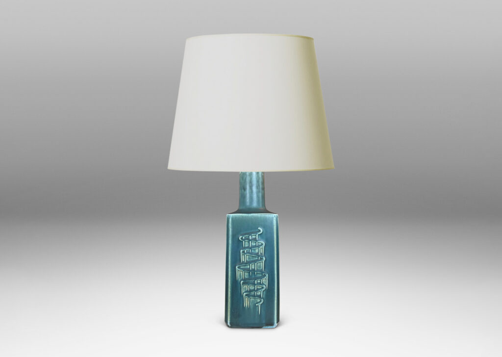 Gallery BAC square pillar forms with chamfered corners and serpentine pattern reliefs, glazed in a matte subdued turquoise