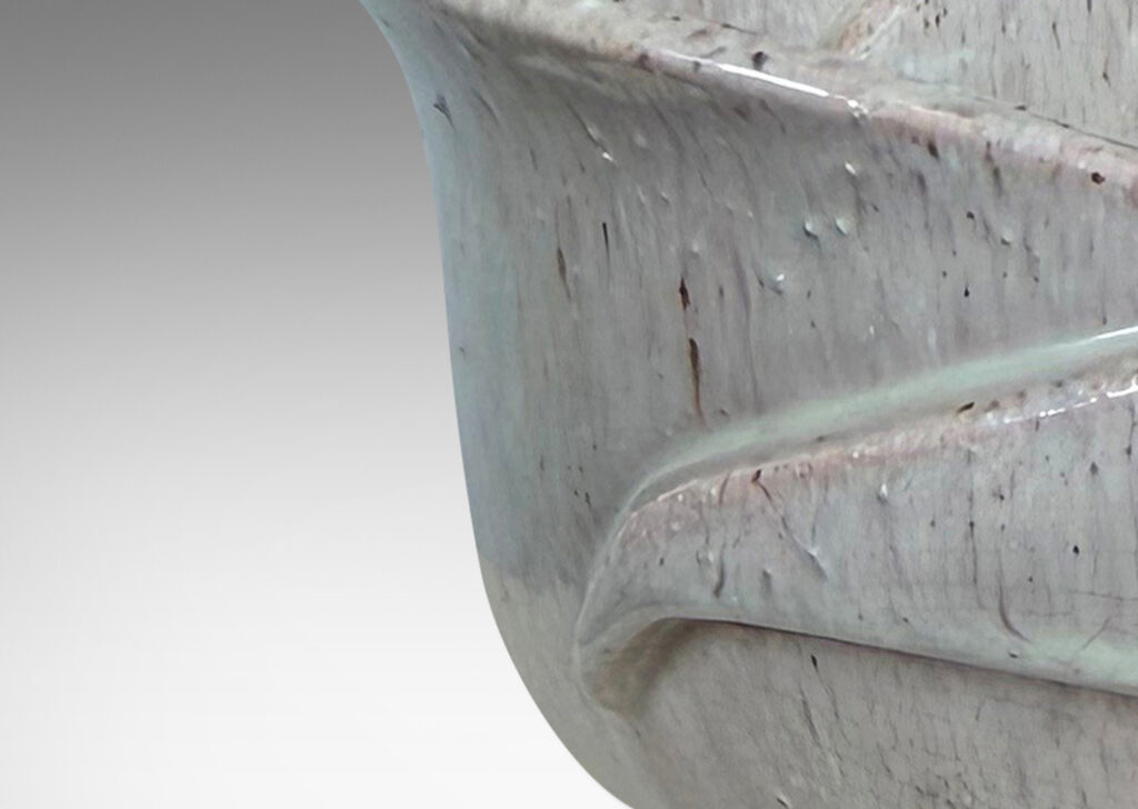Gallery BAC footed abstracted floral design with overlapping petal forms, glazed in a flowing pale rose-gray