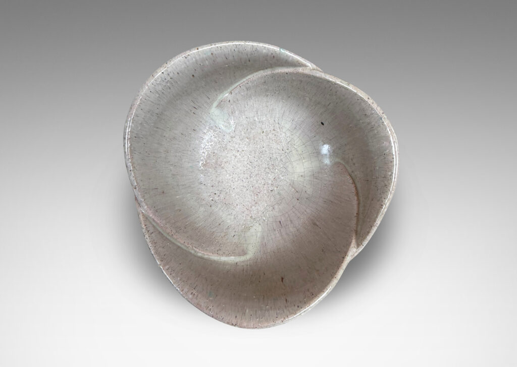 Gallery BAC footed abstracted floral design with overlapping petal forms, glazed in a flowing pale rose-gray