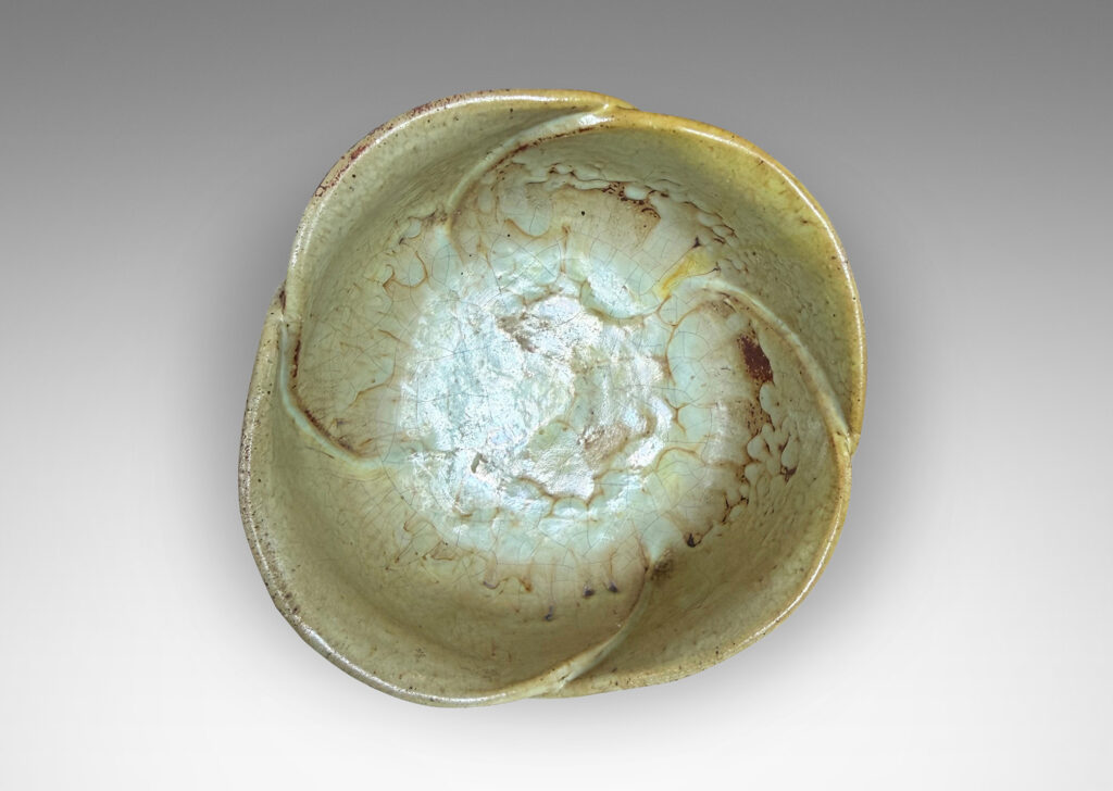 Gallery BAC footed abstracted floral design with overlapping petal forms, glazed in a flowing pale yellow