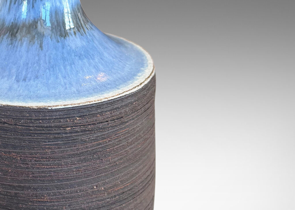 Gallery BAC plump cylindrical form with raked matte brown finish, and a glossy pale gray shoulder