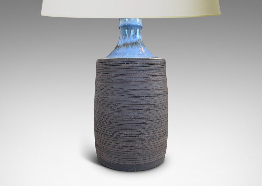 Gallery BAC plump cylindrical form with raked matte brown finish, and a glossy pale gray shoulder