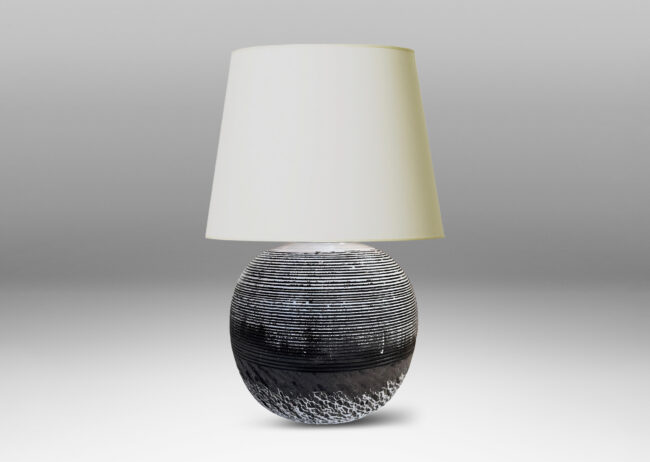 Gallery BAC globe form with carved horizontal ribbing on top and rustic texture on the bottom, glazed in matte brown and shiny white