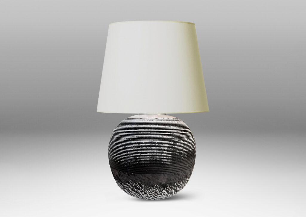 Gallery BAC globe form with carved horizontal ribbing on top and rustic texture on the bottom, glazed in matte brown and shiny white